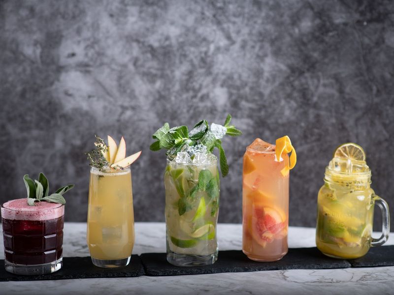Mehrere fertig gemixte Cocktails mit Dekoration
